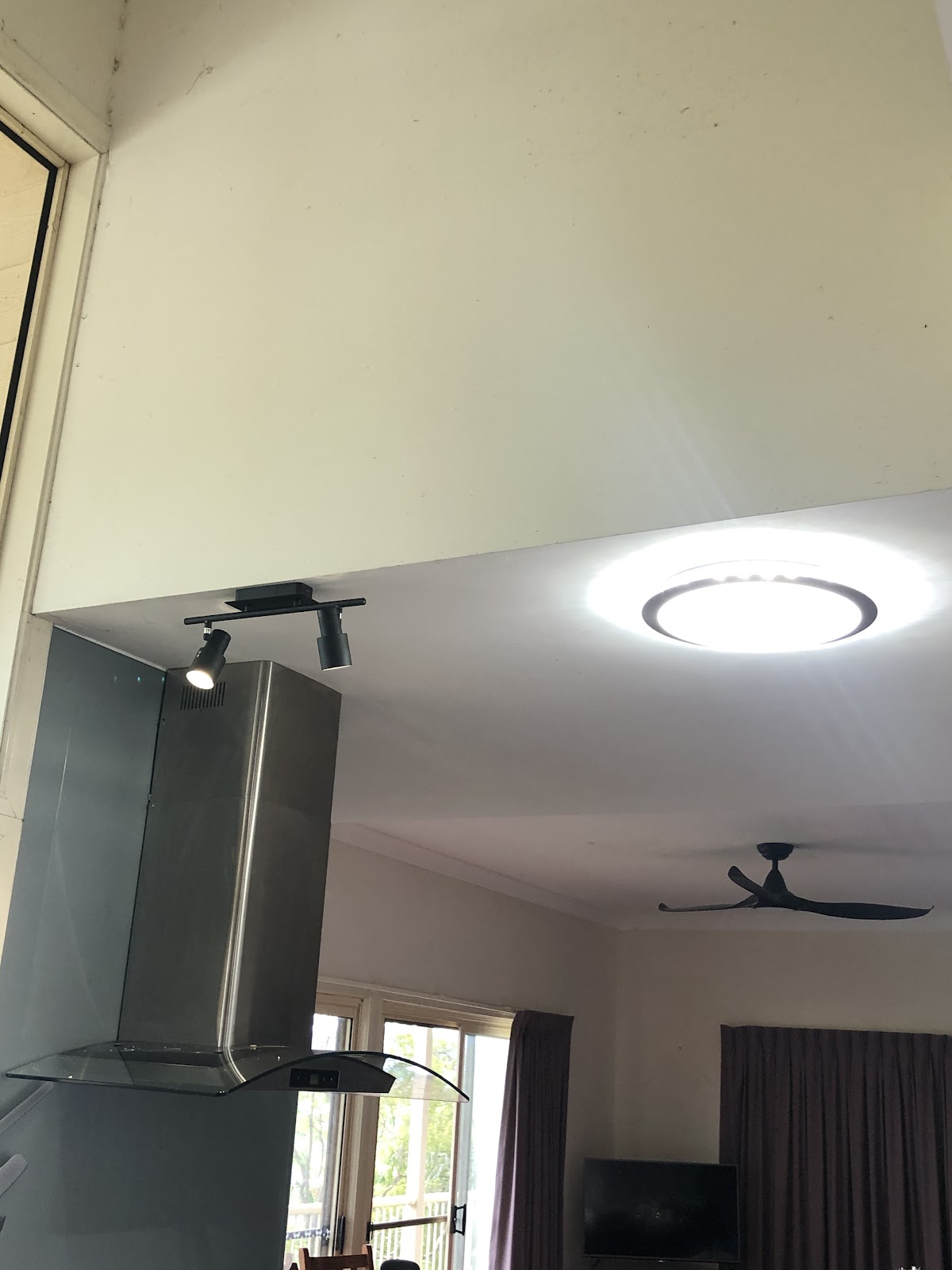 LED ceiling light and track spotlights over a rangehood
