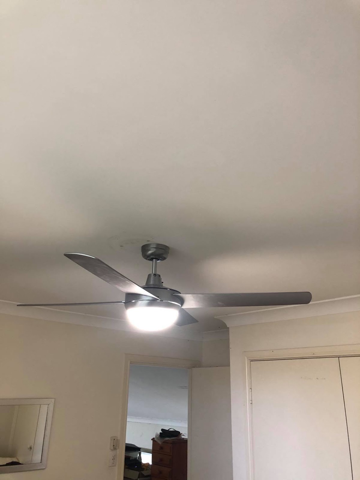 Brushed steel ceiling fan with a light