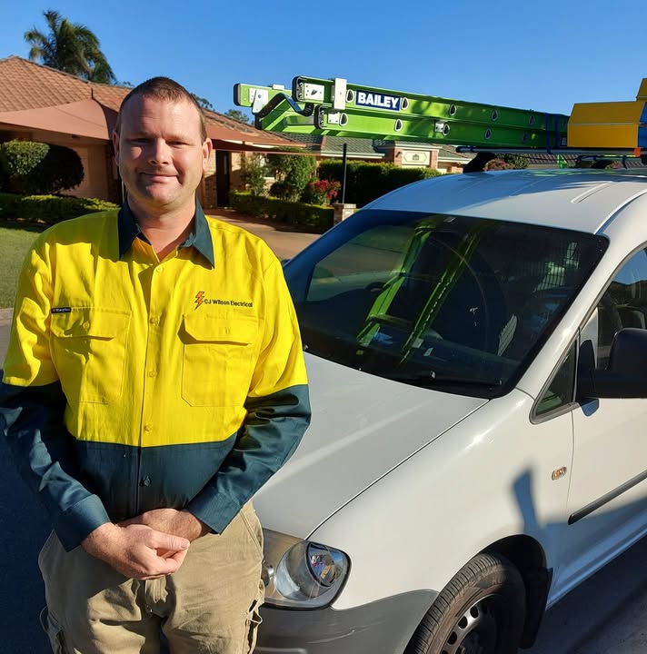 Charlie Wilson in his CJ Wilson Electrical work shirt beside his van